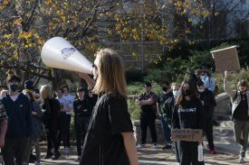 Protester speaking through megaphone at outdoor rally
