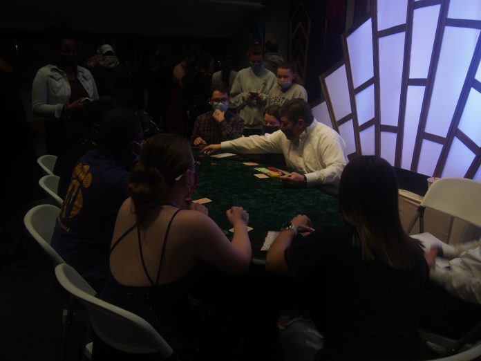 Players focused on a card game table.