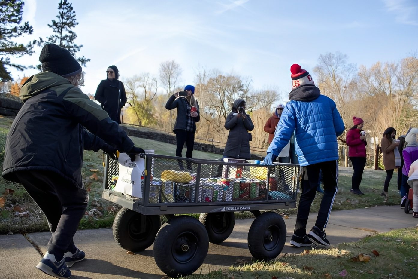 Volunteers transporting food in park setting