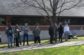 Group waiting on sidewalk