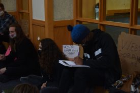 Group sitting on floor, engaged in activity