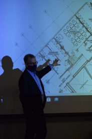 Person pointing at building plans