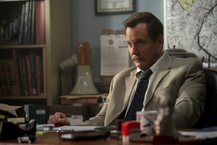 Man in suit sitting at a desk