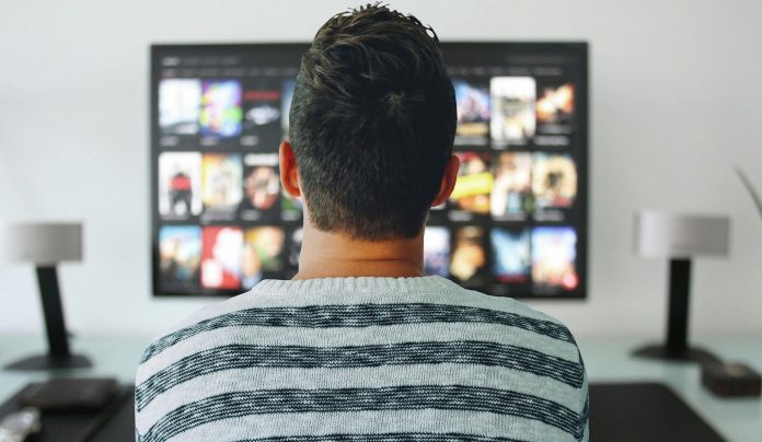 Person watching streaming service on TV