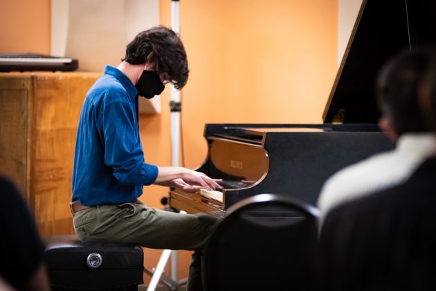Musician with mask playing piano