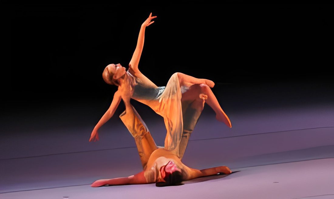 Dancers performing a graceful acrobatic routine