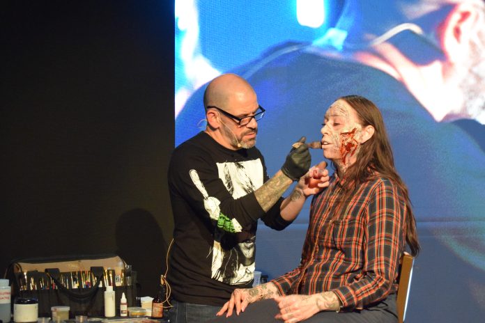 Artist creating realistic wound effects on model