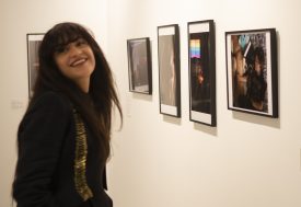 Gallery visitor viewing framed artworks