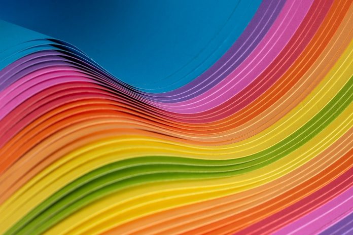 Rainbow-hued paper layers forming curves
