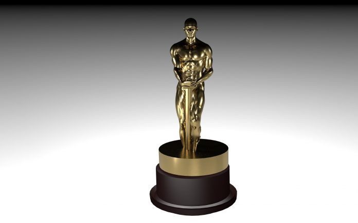 Golden statuette on a dark base