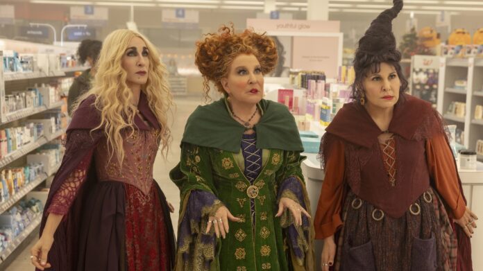 Costumed women standing in a retail aisle