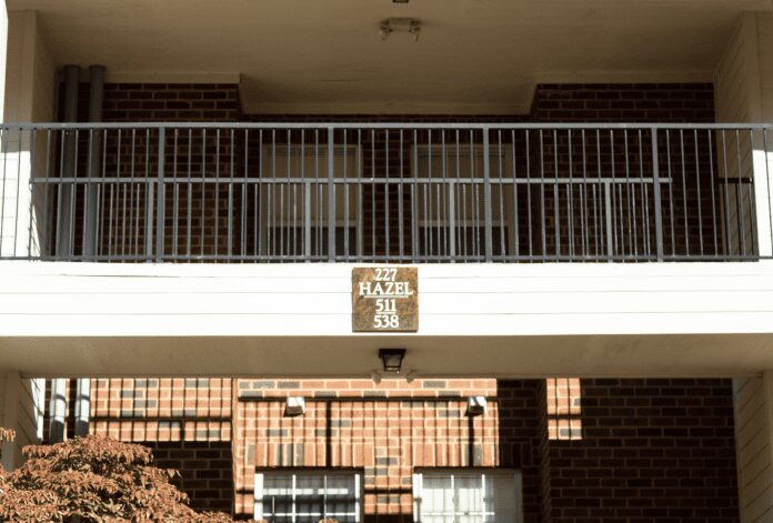 Sunlit apartment exterior with balcony railing