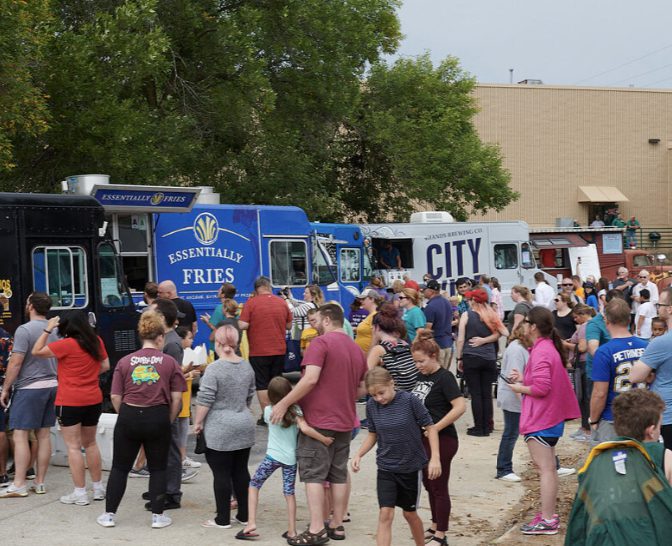 Busy food truck event with visitors