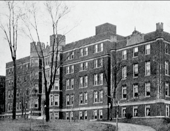Historic brick building with many windows.