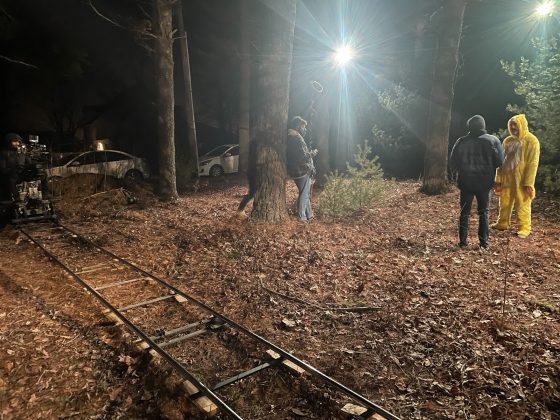 Yellow-suited actor on nighttime movie set