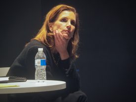 Woman sitting thoughtfully with hand on chin