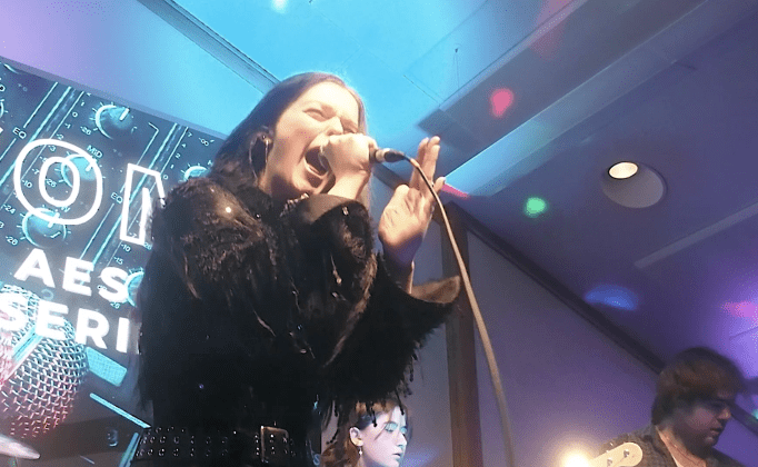 Vocalist holding microphone passionately