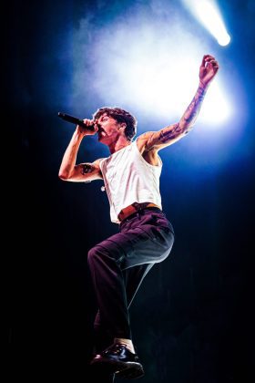 Singer performing energetically on stage