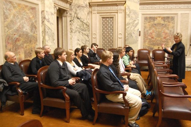 Lecture in ornate room with audience
