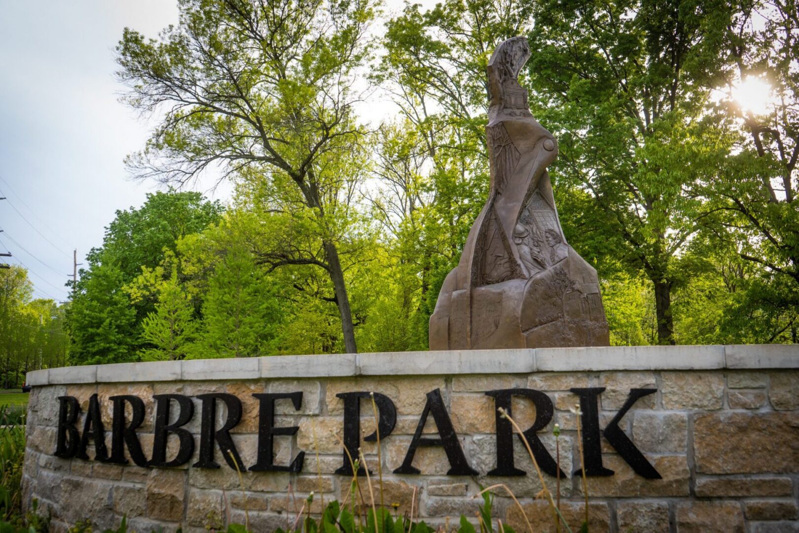 Barbre Park sign amidst lush greenery