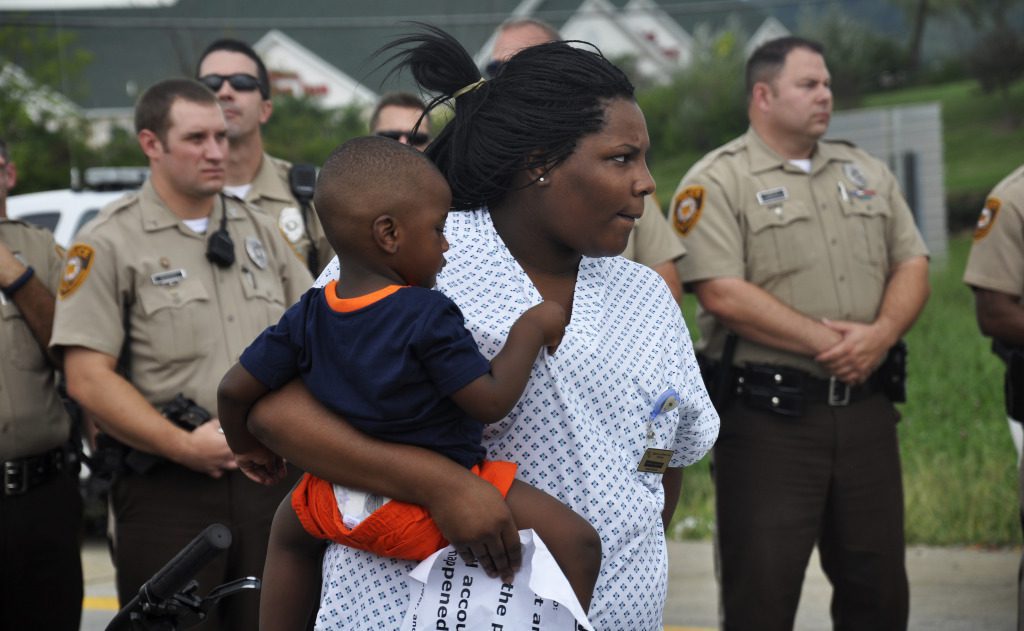 Mother and child with police officers