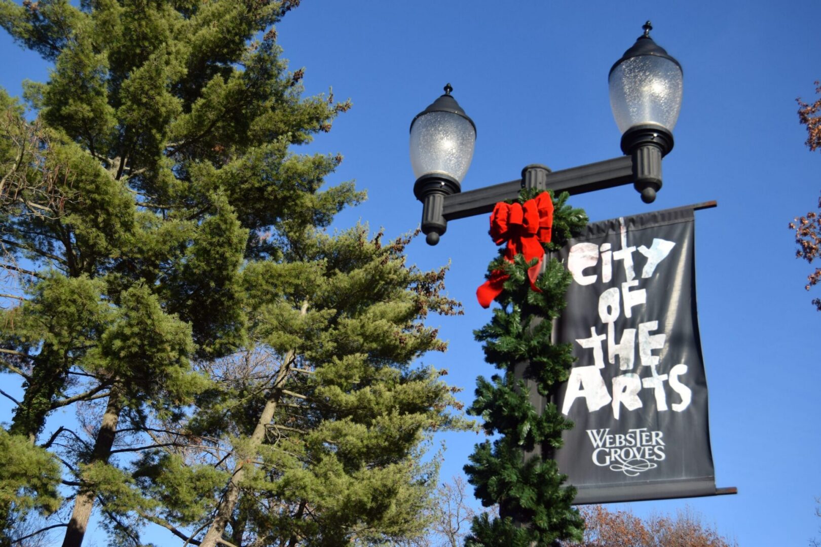 Festive street lamp with greenery and bow