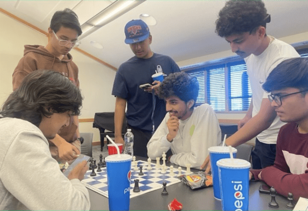 Group of friends playing chess indoors