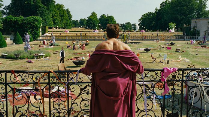 Man overlooking a messy garden party