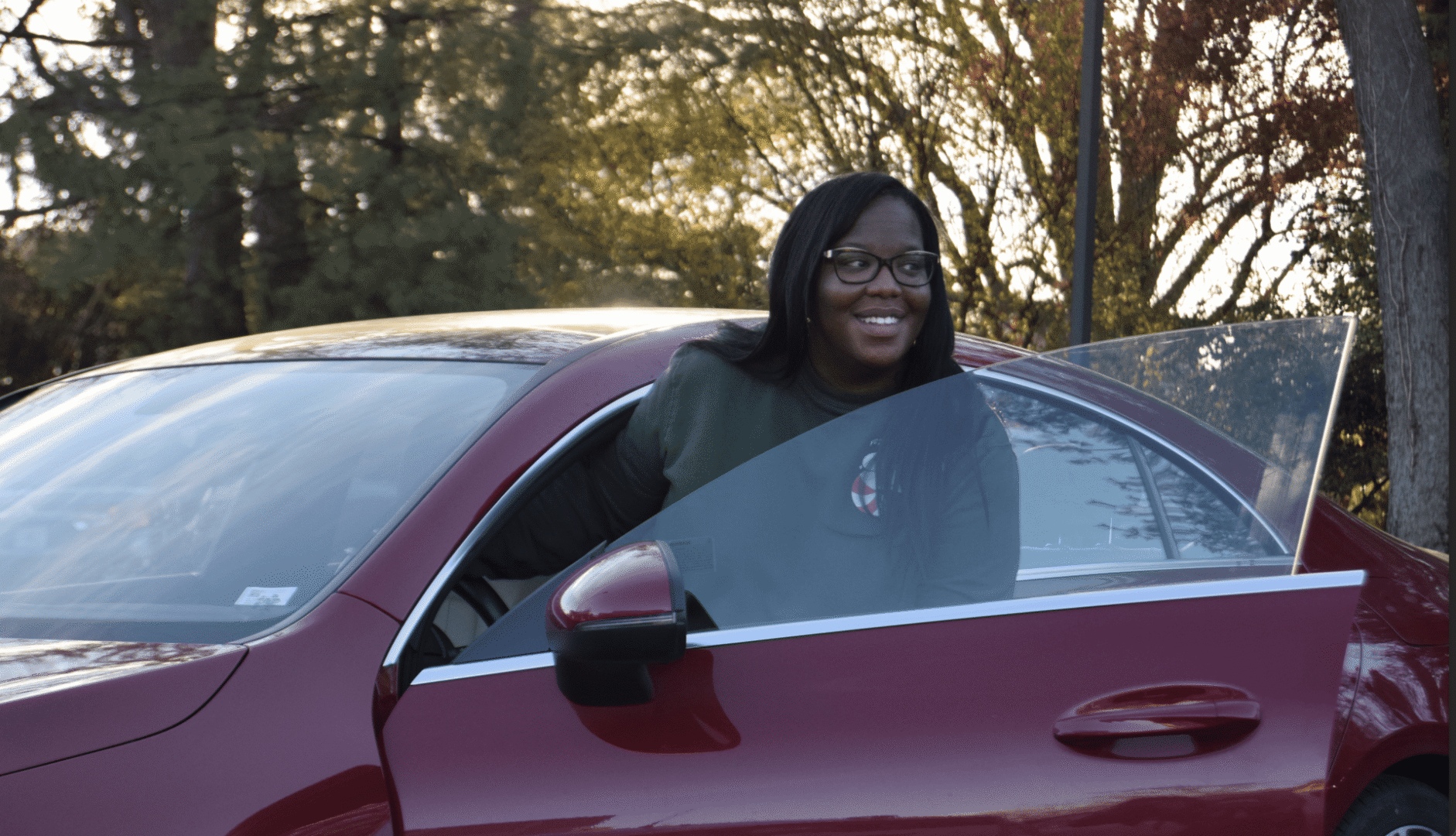 Individual leaving car with open door.