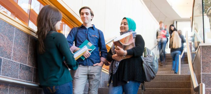 Friends having conversation in school stairway
