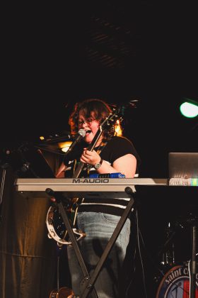 Musician performing with keyboard on stage