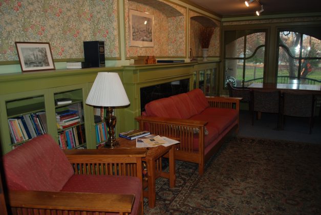 Vintage room with floral wallpaper and sofas