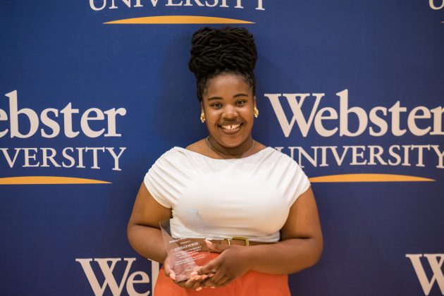 Smiling award recipient at Webster University event