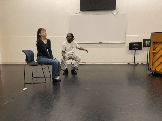 Drama practice with chairs and piano.