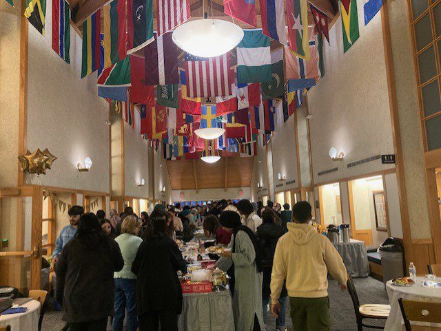 Group socializing in flag-decorated venue.
