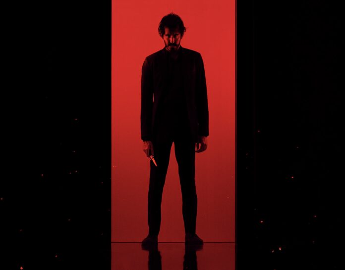 Dark silhouette against red background