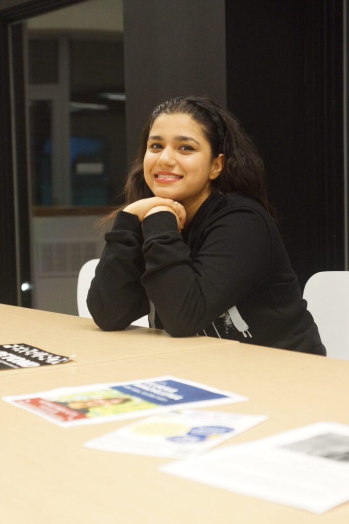 Person smiling at a table