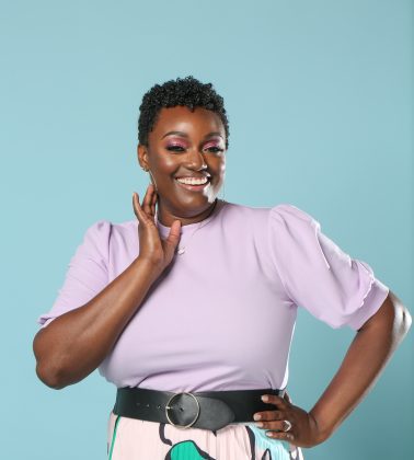 Confident woman posing against blue background