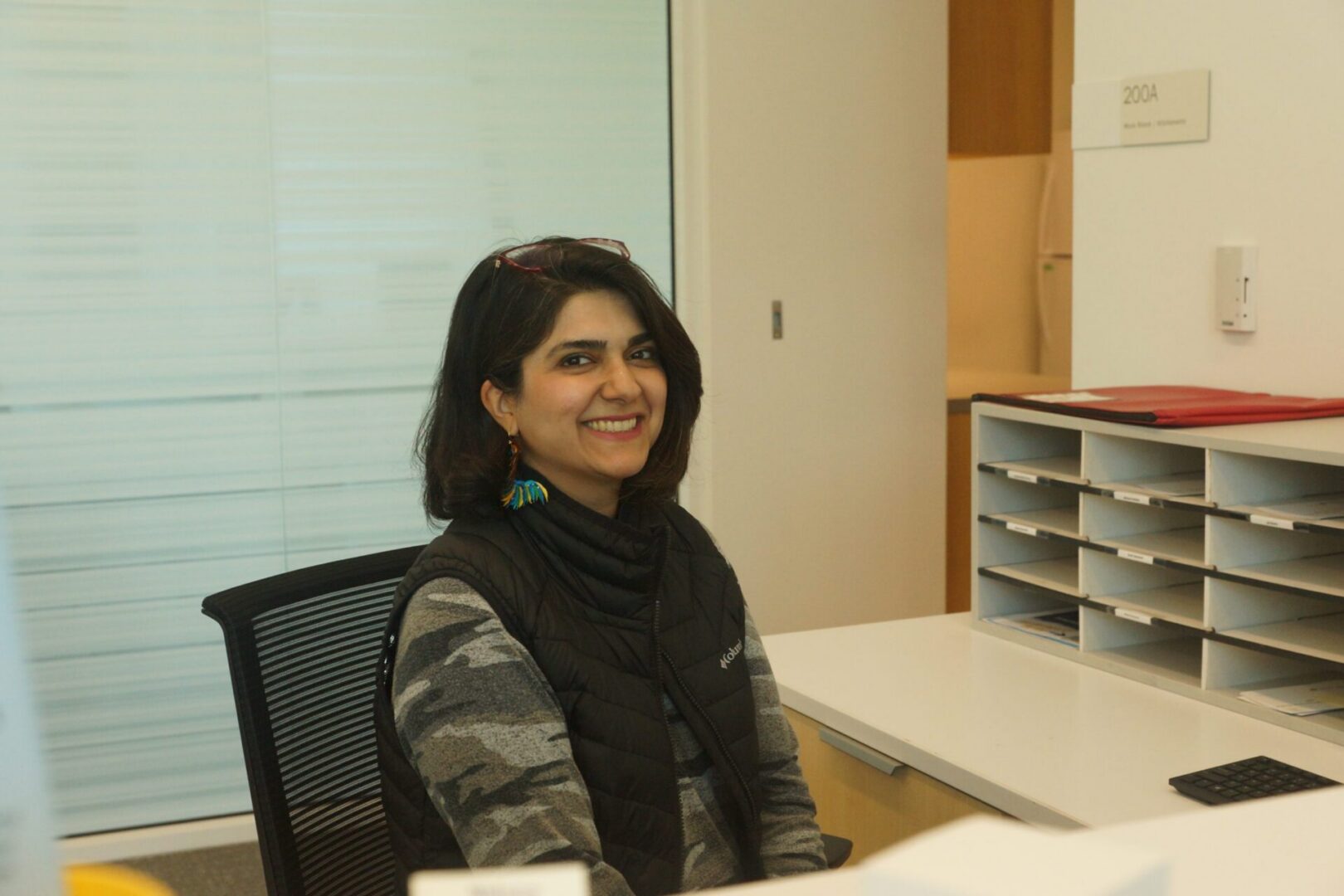 Woman in office setting smiling