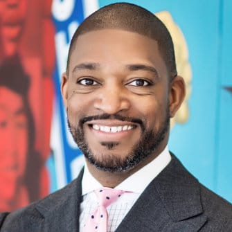 Smiling man in a suit and tie.