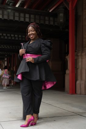 Woman in black and pink outfit smiling