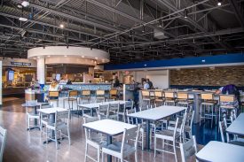 Empty modern cafeteria with tables and chairs