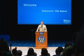 Speaker at podium during presentation