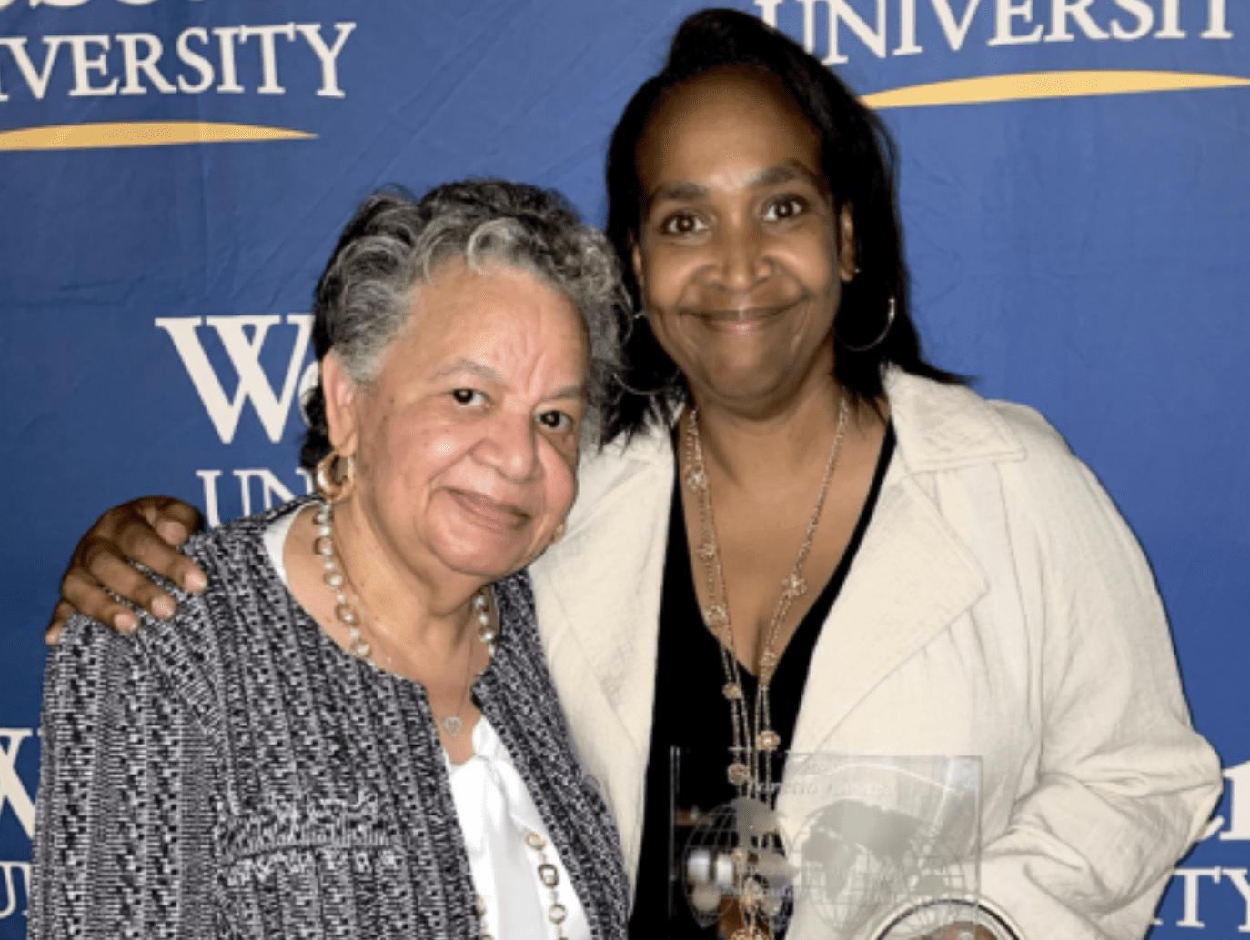 Women posing with awards at ceremony
