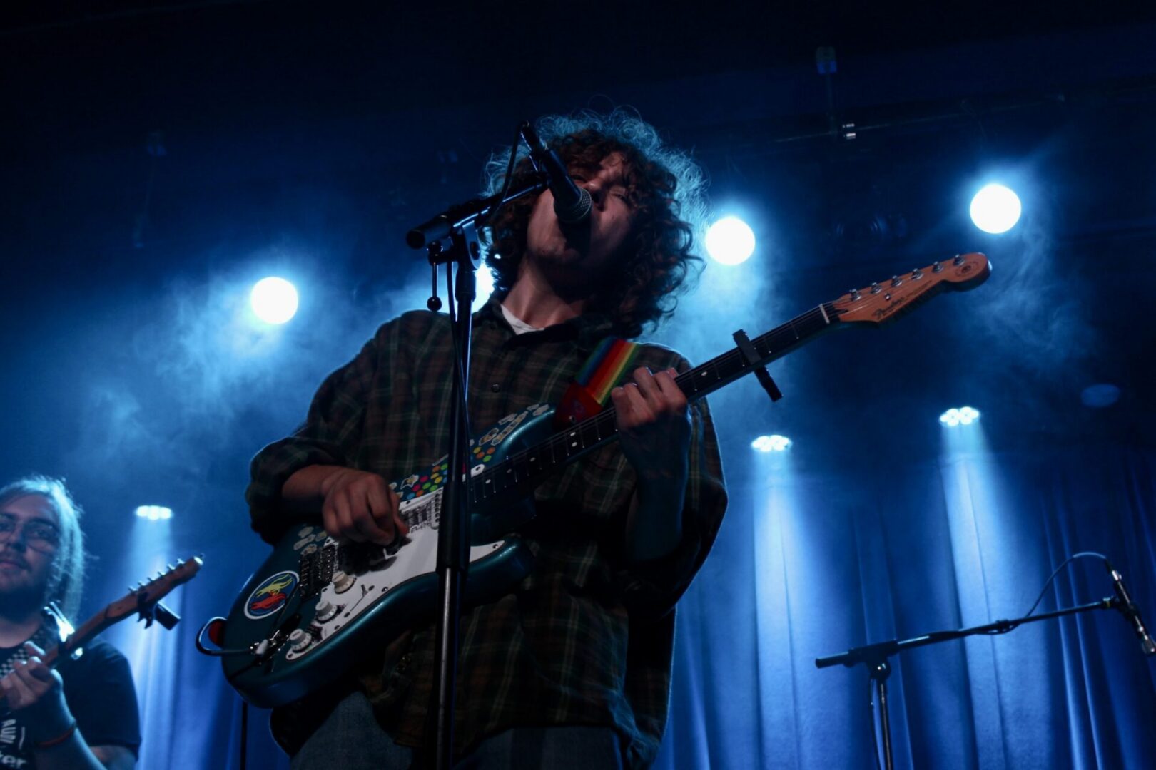 Musician performing with electric guitar on stage