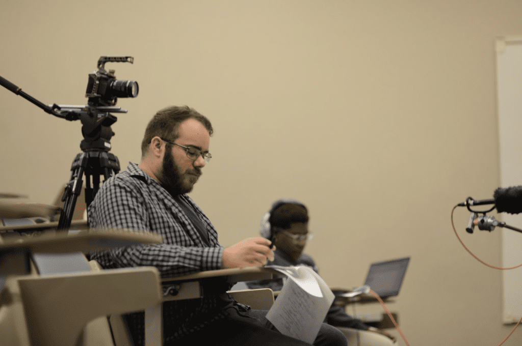 Man holding paper in lecture hall