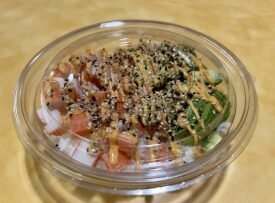 Salmon poke bowl with sauce drizzle