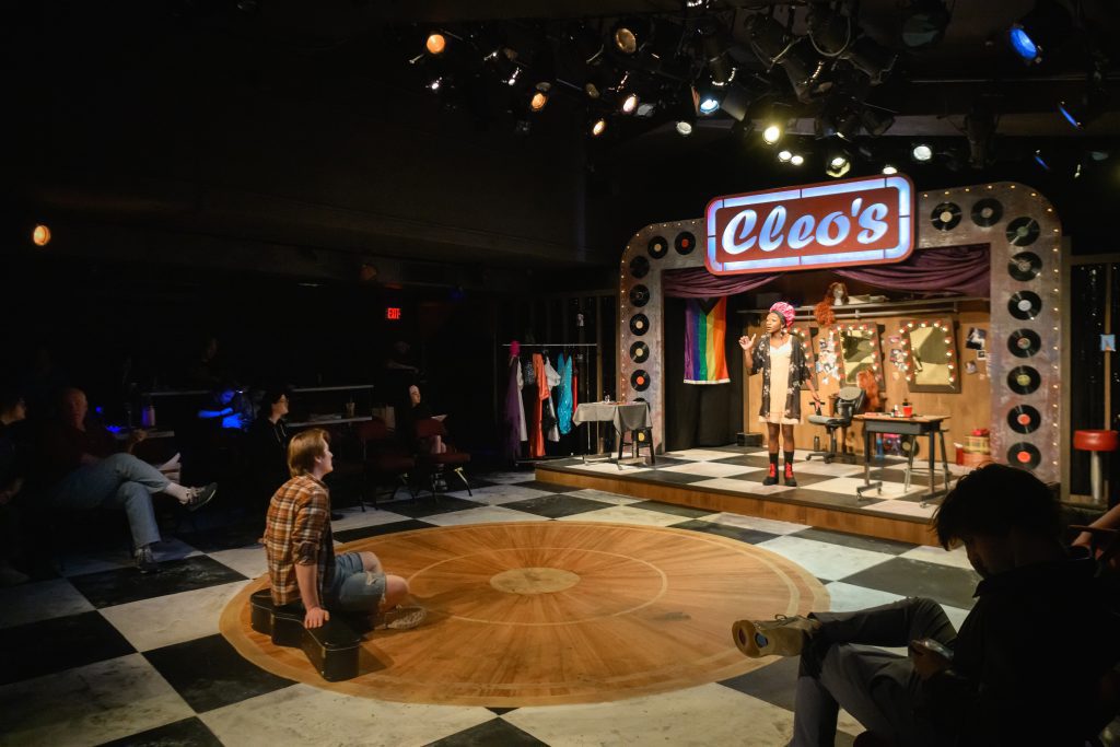 Intimate theater scene with spotlight stage