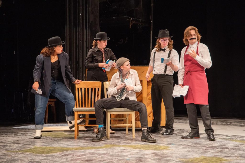 Five people acting in a play