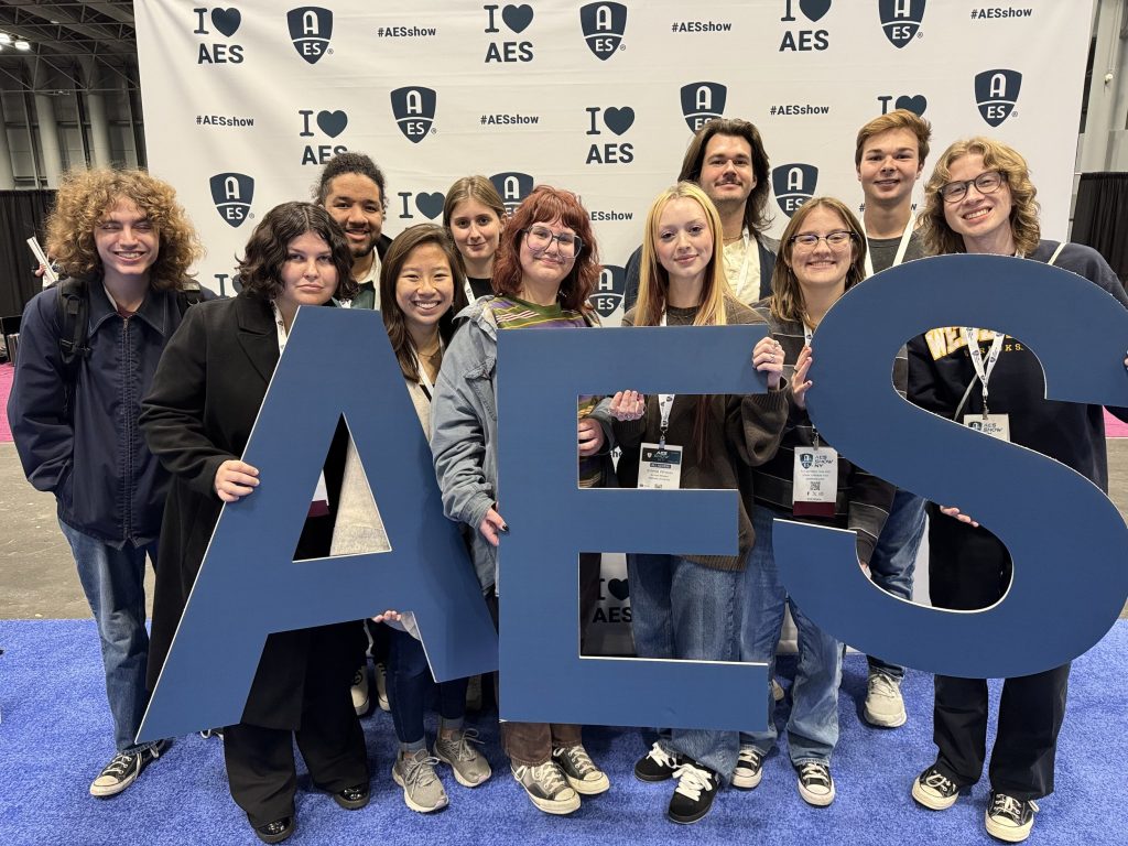 Friends posing with AES sign